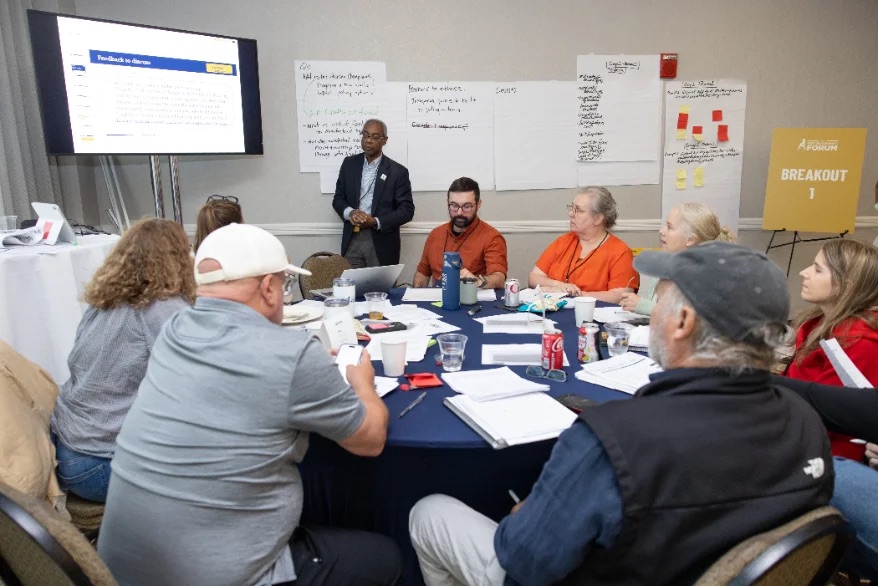 Delegates around a table in a breakout working session